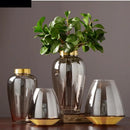 modern glass vase with metal base for floral decoration