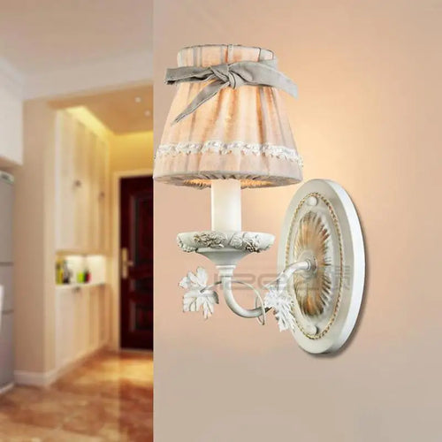 Iron wall light with fabric lampshade and ribbon bow