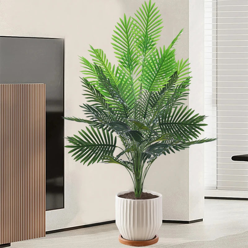 Artificial palm tree with plastic monstera leaves for garden