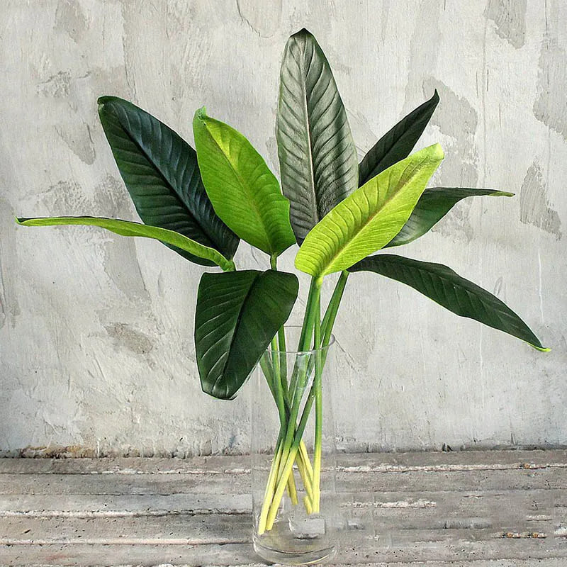 Tropical floral arrangement with decorative birds and bananas for weddings