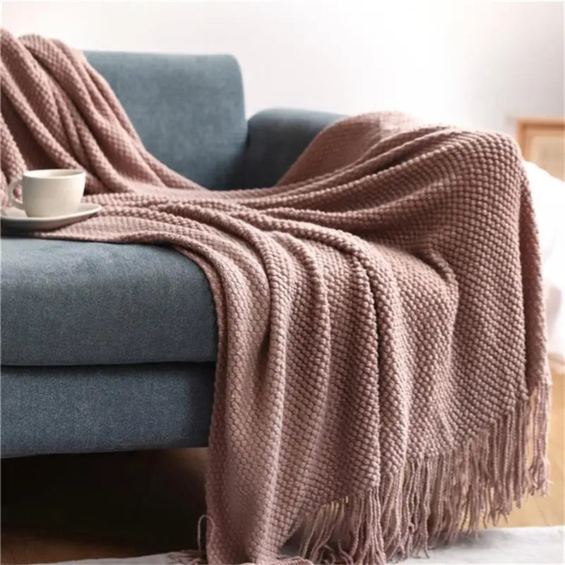 Nordic knitted check throw with soft pom-poms