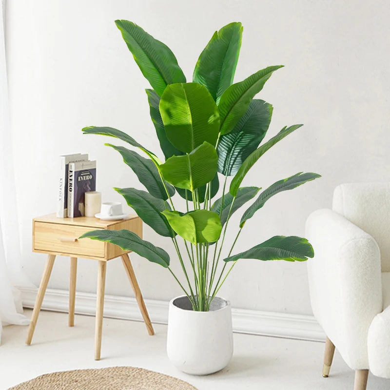 Large artificial tropical palm tree with banana and strelitzia leaves