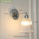 Contemporary chrome glass and iron wall light with adjustable arm
