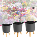 round flower pot on wooden stand for plants