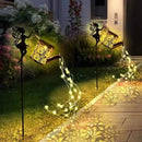 Solar watering can with garden lights and fairy statues