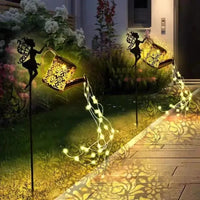 Solar watering can with garden lights and fairy statues