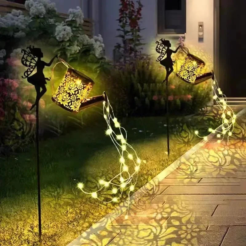 Solar watering can with garden lights and fairy statues