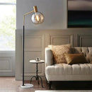 Elegant gold and black floor lamp in metal and glass