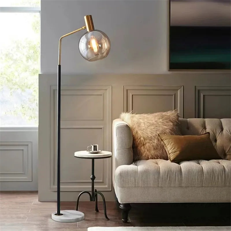 Elegant gold and black floor lamp in metal and glass
