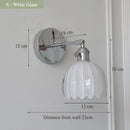 Contemporary chrome glass and iron wall light with adjustable arm