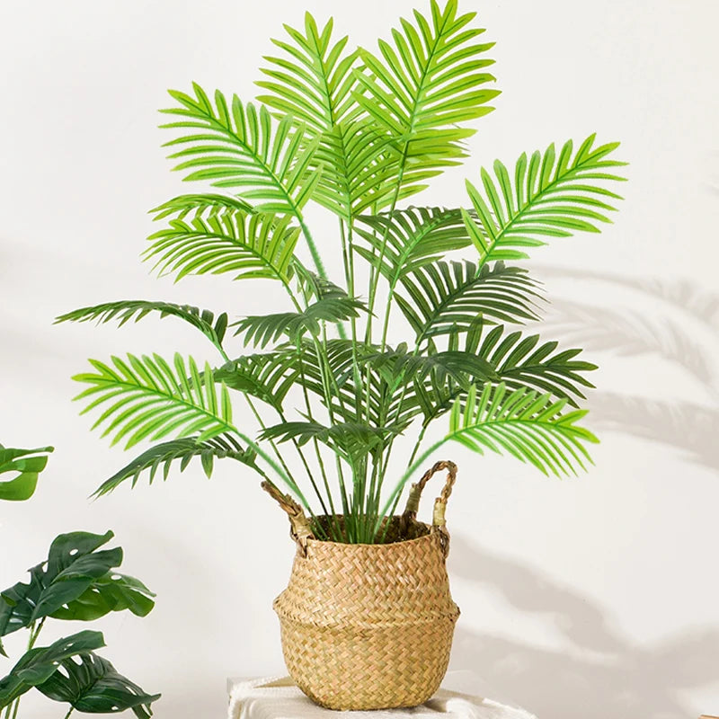 Large artificial palm tree with monstera branches for outdoor decoration