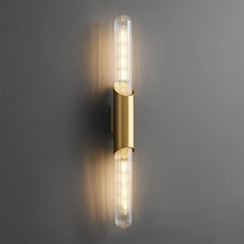 Minimalist brass wall light with clear glass