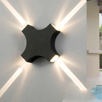 Narrow LED wall light with four beams for outdoor garden lighting