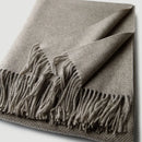 Soft wool throw with spiral pattern and fringes