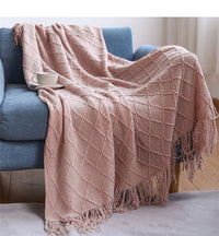 Lightweight acrylic knitted throw with pom poms, cosy style