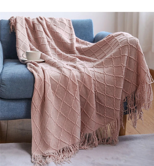 Lightweight acrylic knitted throw with pom poms, cosy style