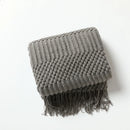 Lightweight knitted check throw with decorative tassels