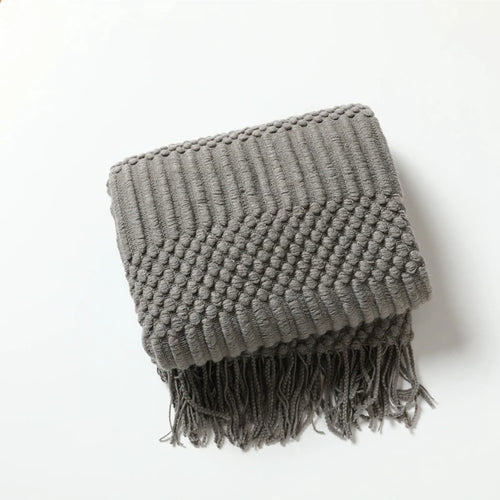 Lightweight knitted check throw with decorative tassels