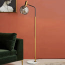 Elegant gold and black floor lamp in metal and glass