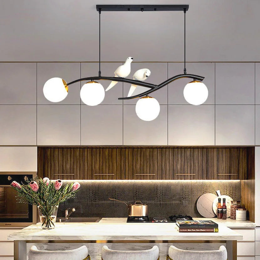 Iron chandelier with bird and suspended glass ball