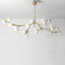 Glass chandelier with tree branches and glowing glass balls