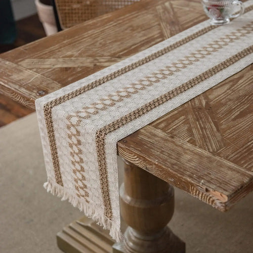 Beige boho table runner with geometric patterns and tassels