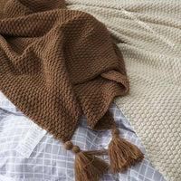 Waffle knit chunky throw blanket with pom poms nordic style