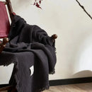 Lightweight cotton muslin throw with decorative tassels for living room