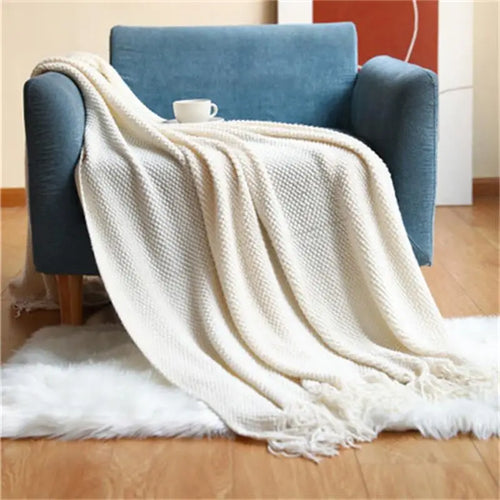 Nordic knitted throw with pompoms for bed or sofa