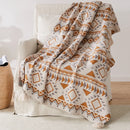 Bohemian striped knit throw with geometric pattern and pompom trim