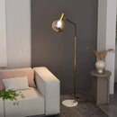 Elegant gold and black floor lamp in metal and glass