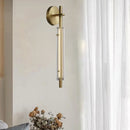 Minimalist brass wall light with clear glass and 3 brightness levels