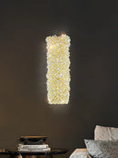 Gold metal wall light with clear crystal bulb and adjustable wire