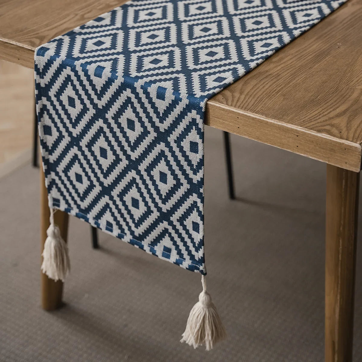 Beige and black geometric table runner with tassels, bohemian style