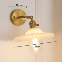 Gold LED wall light with glass lampshade