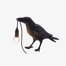 LED wall light with bird holding a lamp in its beak