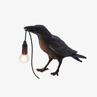 LED wall light with bird holding a lamp in its beak