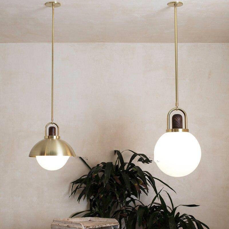 Led designer pendant light with glass globe and gold metal