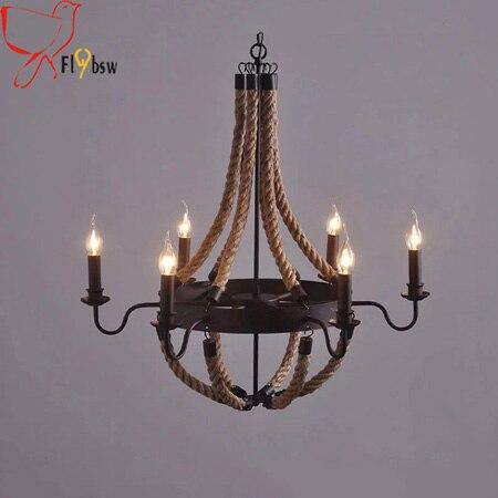 Rustic chandelier in metal and ropes with burning lamps