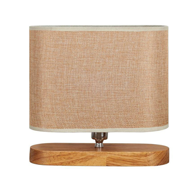 Wooden bedside lamp with oval fabric shade