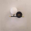 Gold wall light with glass globe