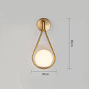 Gold LED designer wall light with white globe sconce