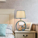 LED table lamp with sculpted body and fabric shade
