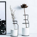 Scandinavian design ceramic vase with metal sticks