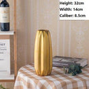 Designer vase in golden ceramic with a geometric style