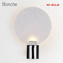 Designer LED wall light in metal with glass disc Sconce