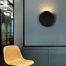 Design LED wall light with curved metal tile
