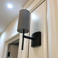 Designer LED wall light with gray cylindrical lampshade