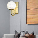 Design LED wall light with rounded gold stem and white globe luxury