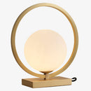 Designer LED table lamp with gold circle and glass globe